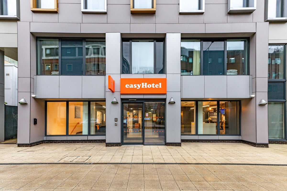 easyHotel Cardiff exterior building, featuring the orange easyHotel sign above the glass entrance doors on a modern gray facade.