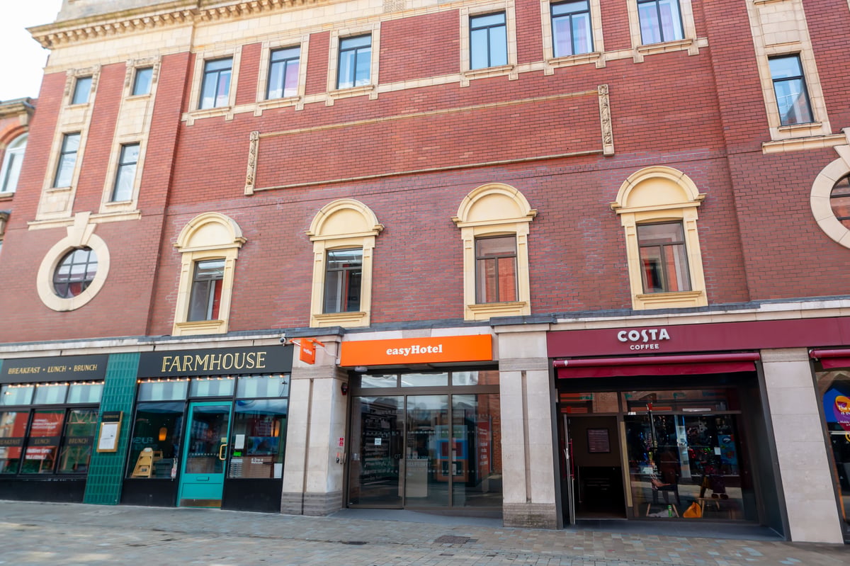 easyHotel Leeds City Centre exterior, red brick building with arched windows and easyHotel signage.