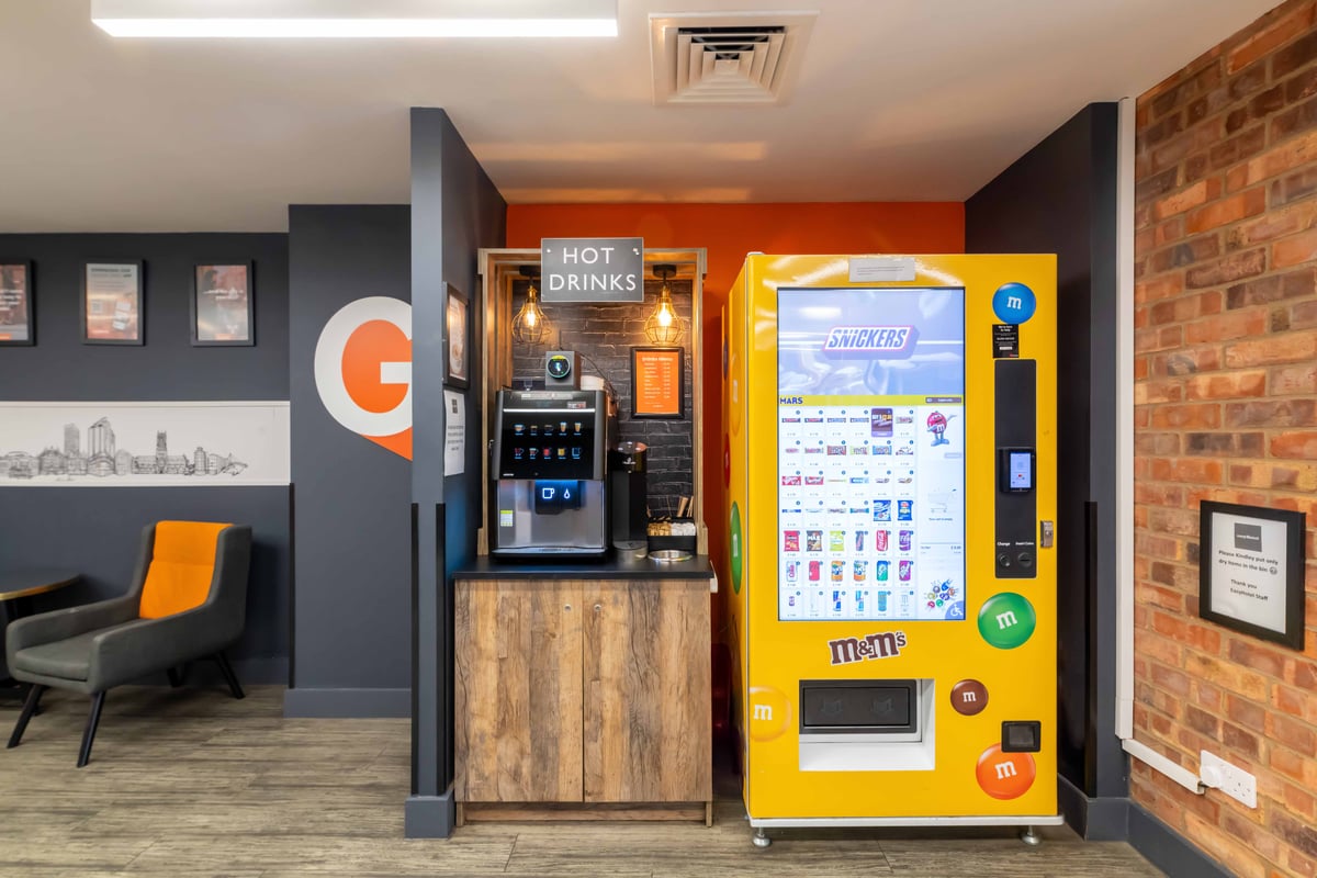 easyHotel Leeds City Centre reception area featuring a vending machine with snacks and drinks, and a hot drinks machine.