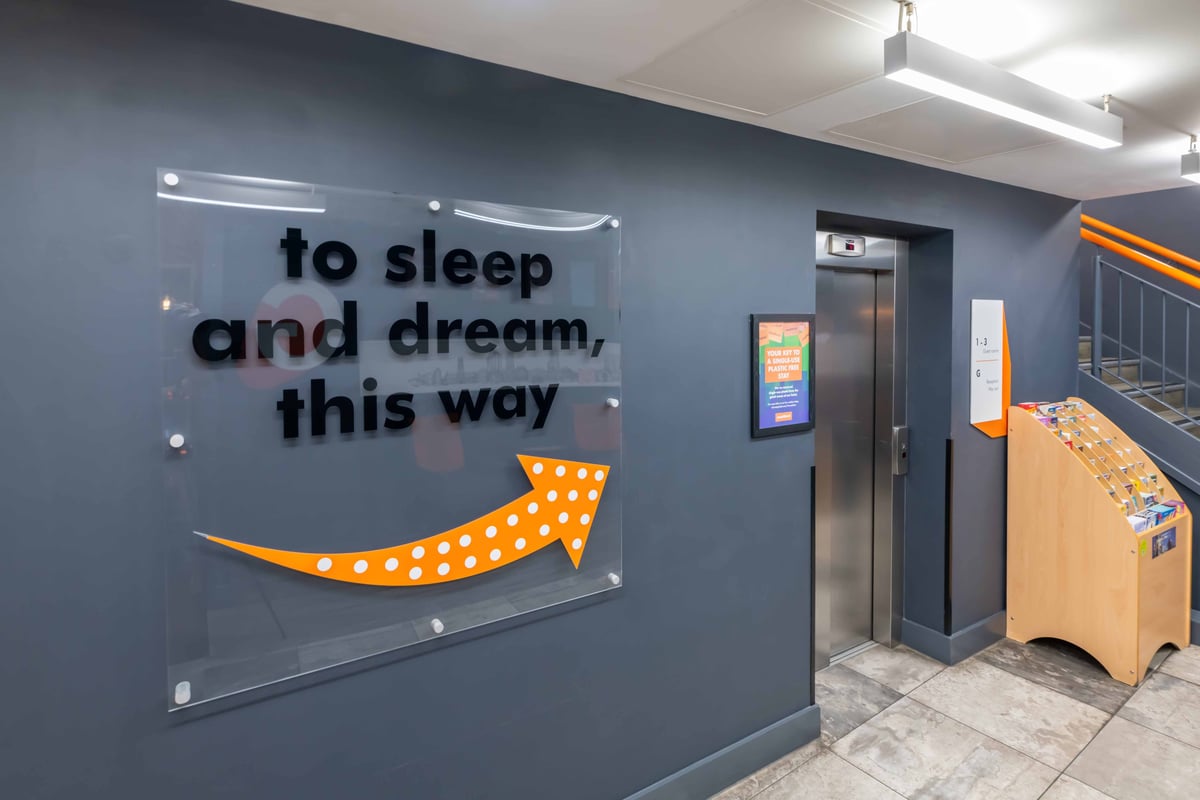 easyHotel Leeds City Centre reception area with a sign directing guests to the sleeping area.