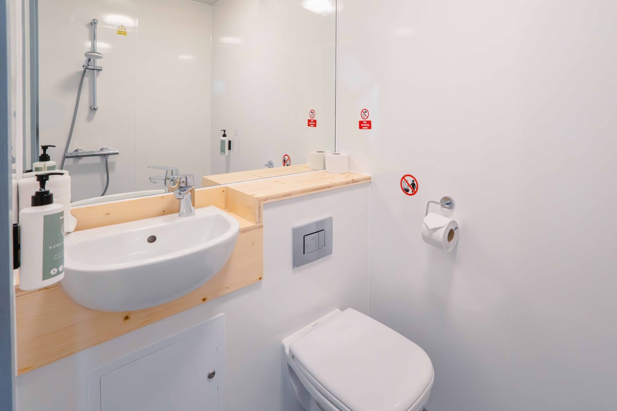EasyHotel London Croydon bathroom with white sink, toilet, and shower.
