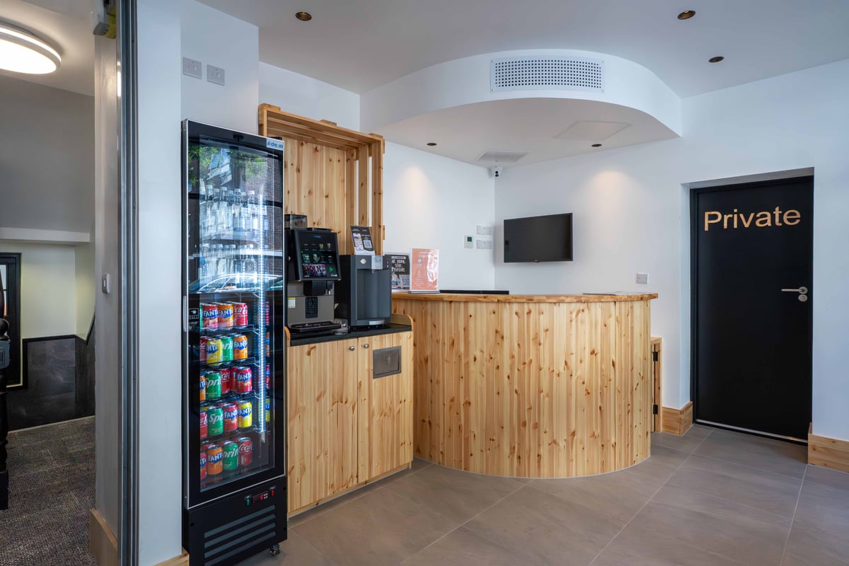 easyHotel London Paddington reception desk with a vending machine and coffee/tea station.